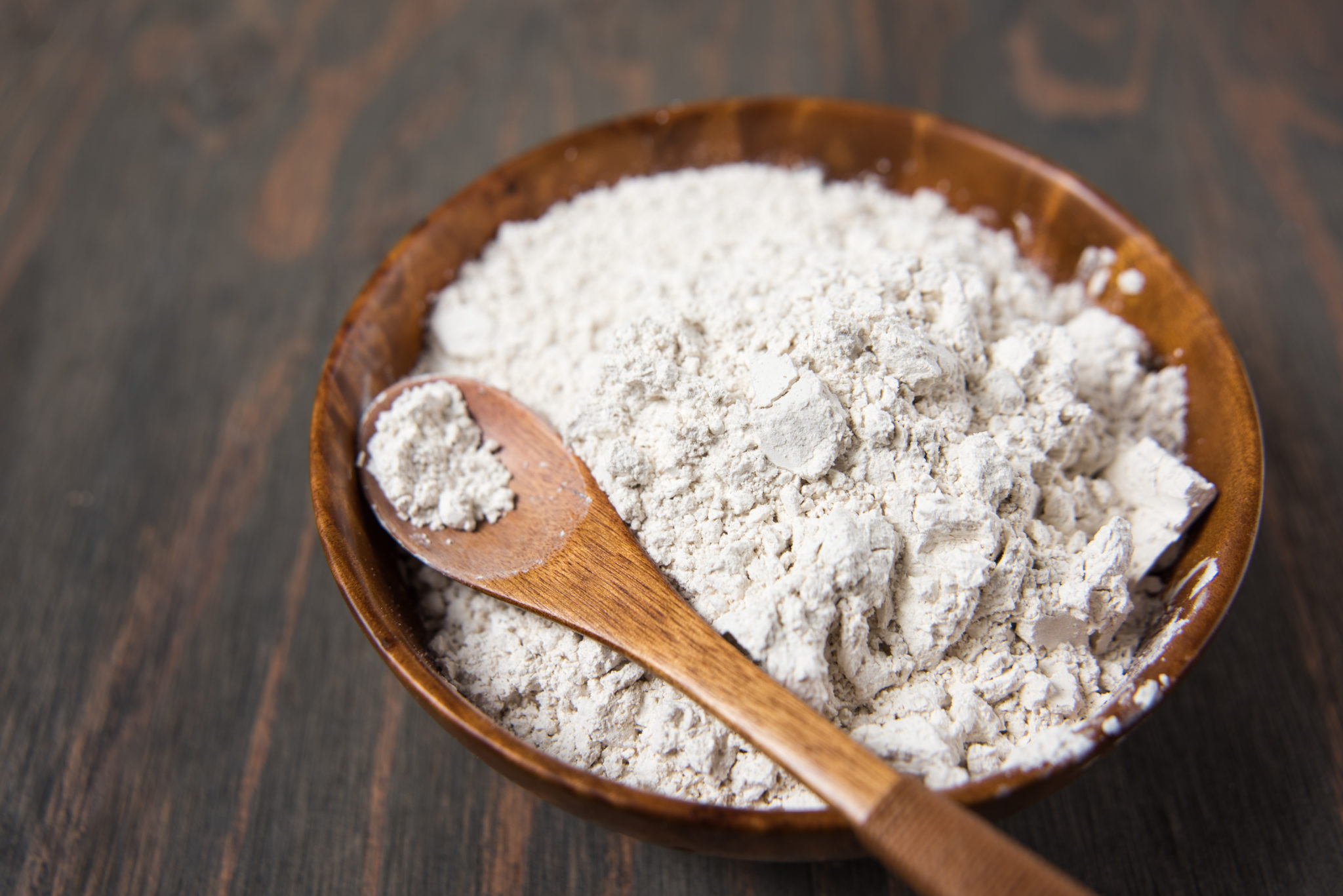 Diatomaceous Earth in a wooden bowl sitting on a table